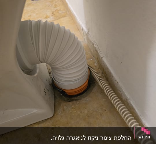 צינור גמיש מחובר לרצפה ליד קיר